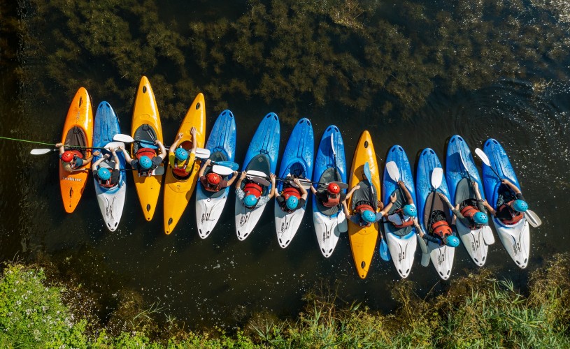 Bird's eye view of people in yellow and blue kayaks
